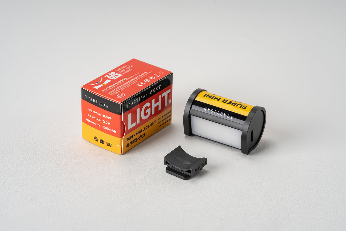 TTArtisan mini LED light with its retail box and hot shoe mount