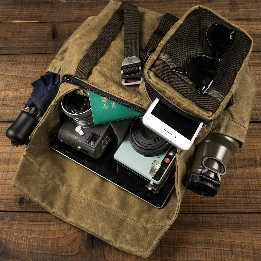 Wotancraft Pilot 7L khaki bag packed with Leica camera, lenses, passport and phone