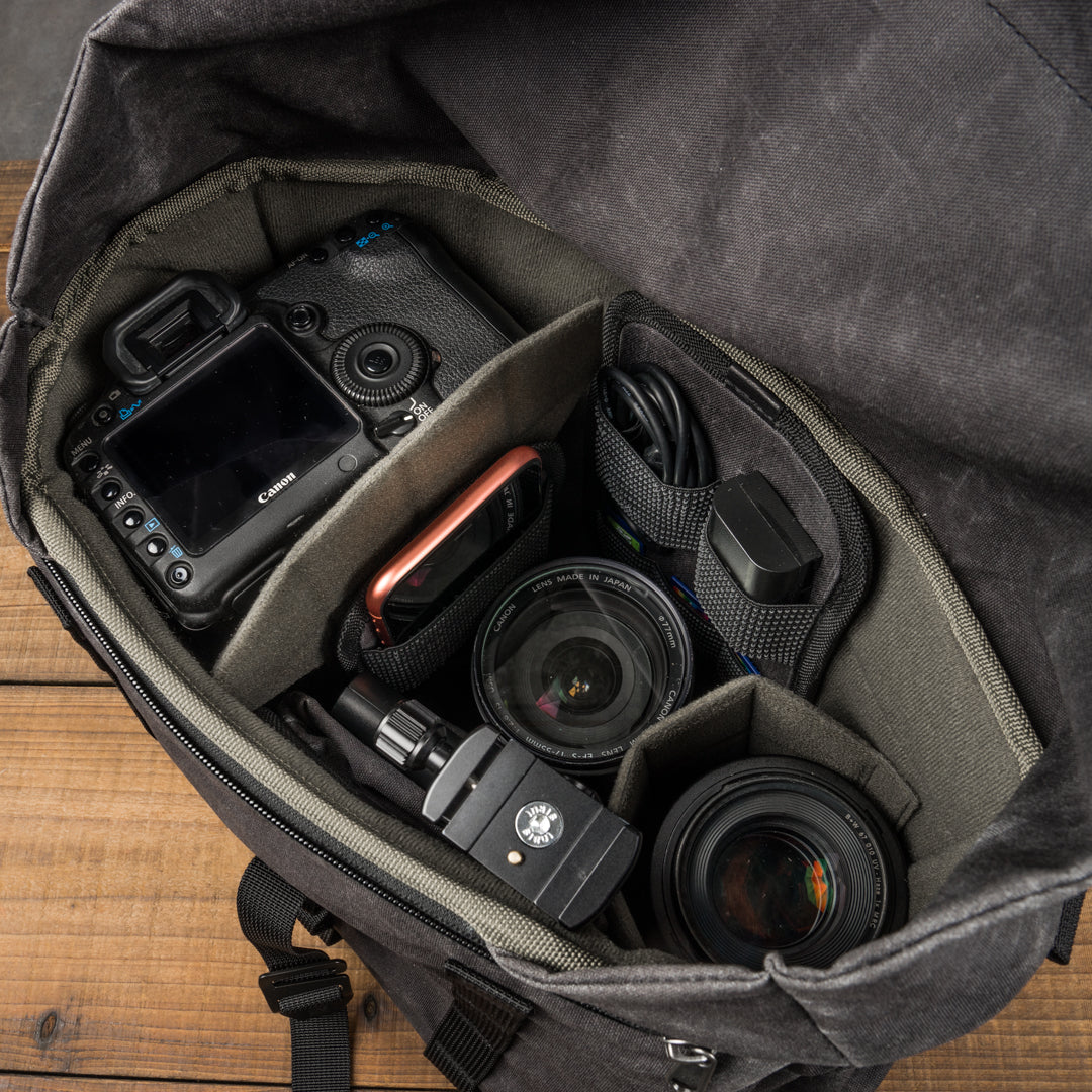 Wotancraft Pilot 10L charcoal bag open with Canon DSLR and lenses in the insert