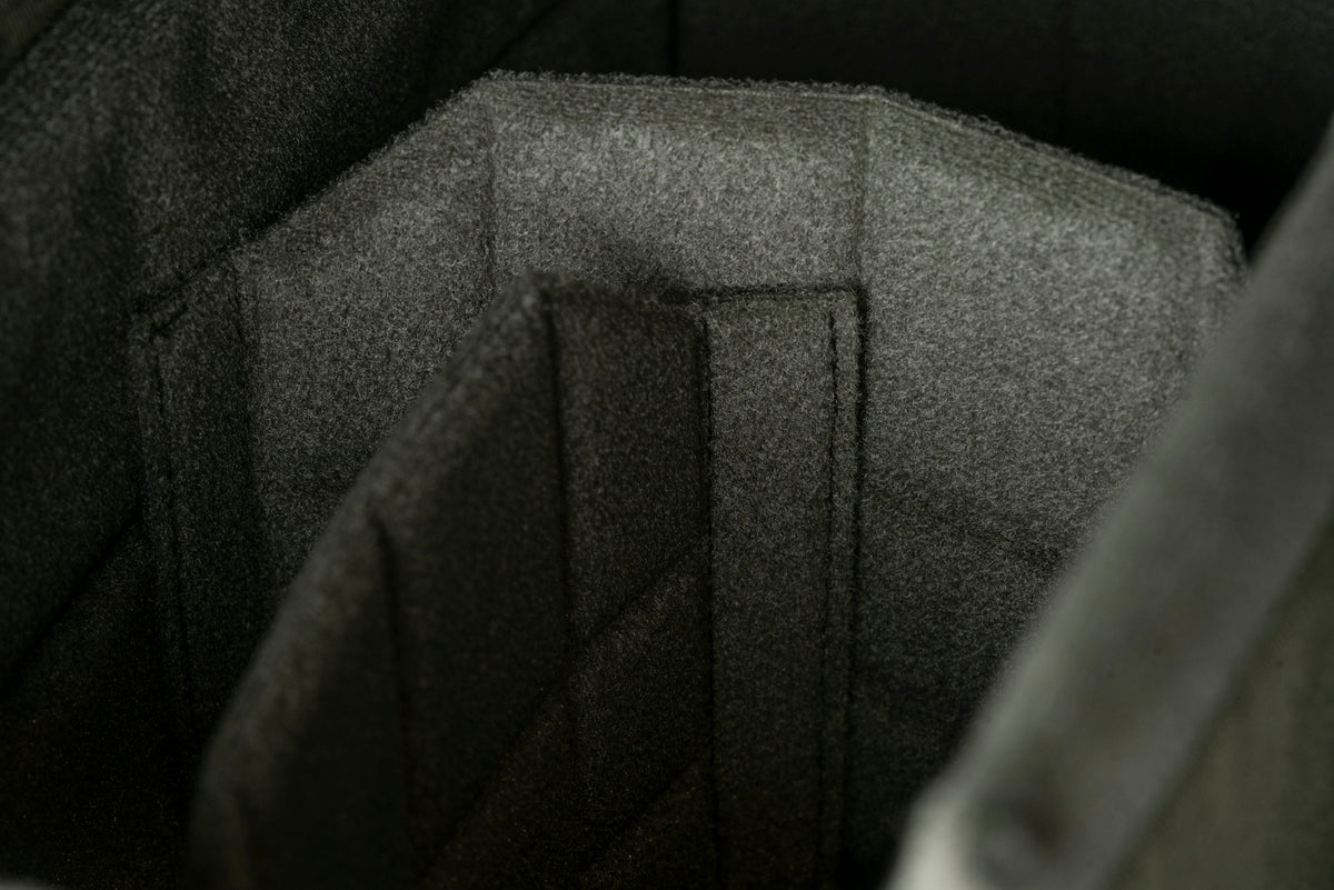 Hand lifting the flap of a Wotancraft insert holding three cameras
