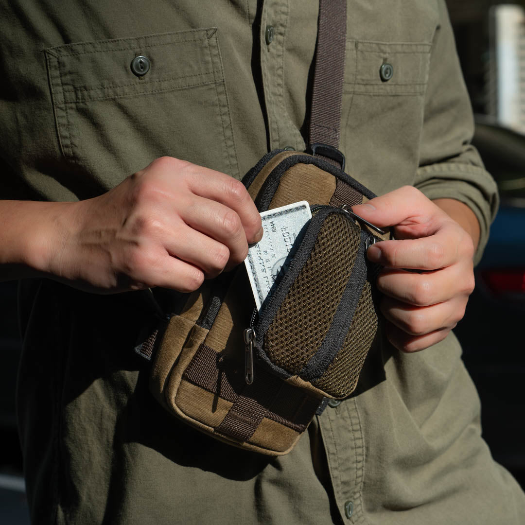 Man slipping a card into the Wotancraft coin pouch