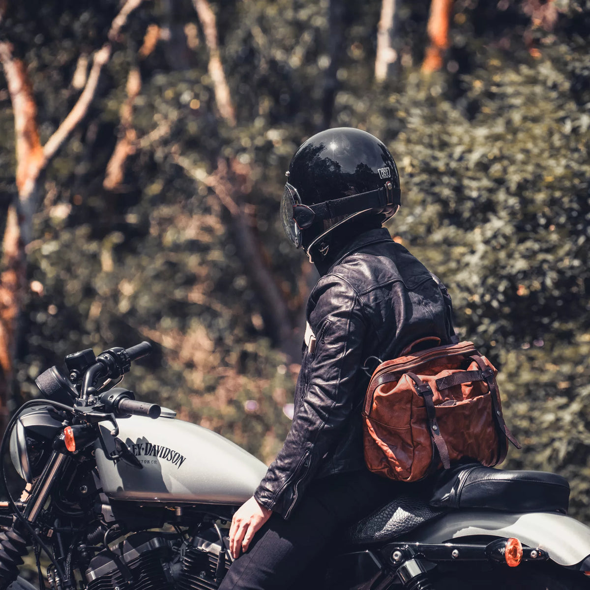 Motorcyclist on a Harley-Davidson wearing the Wotancraft Lightning Rider brown leather bag