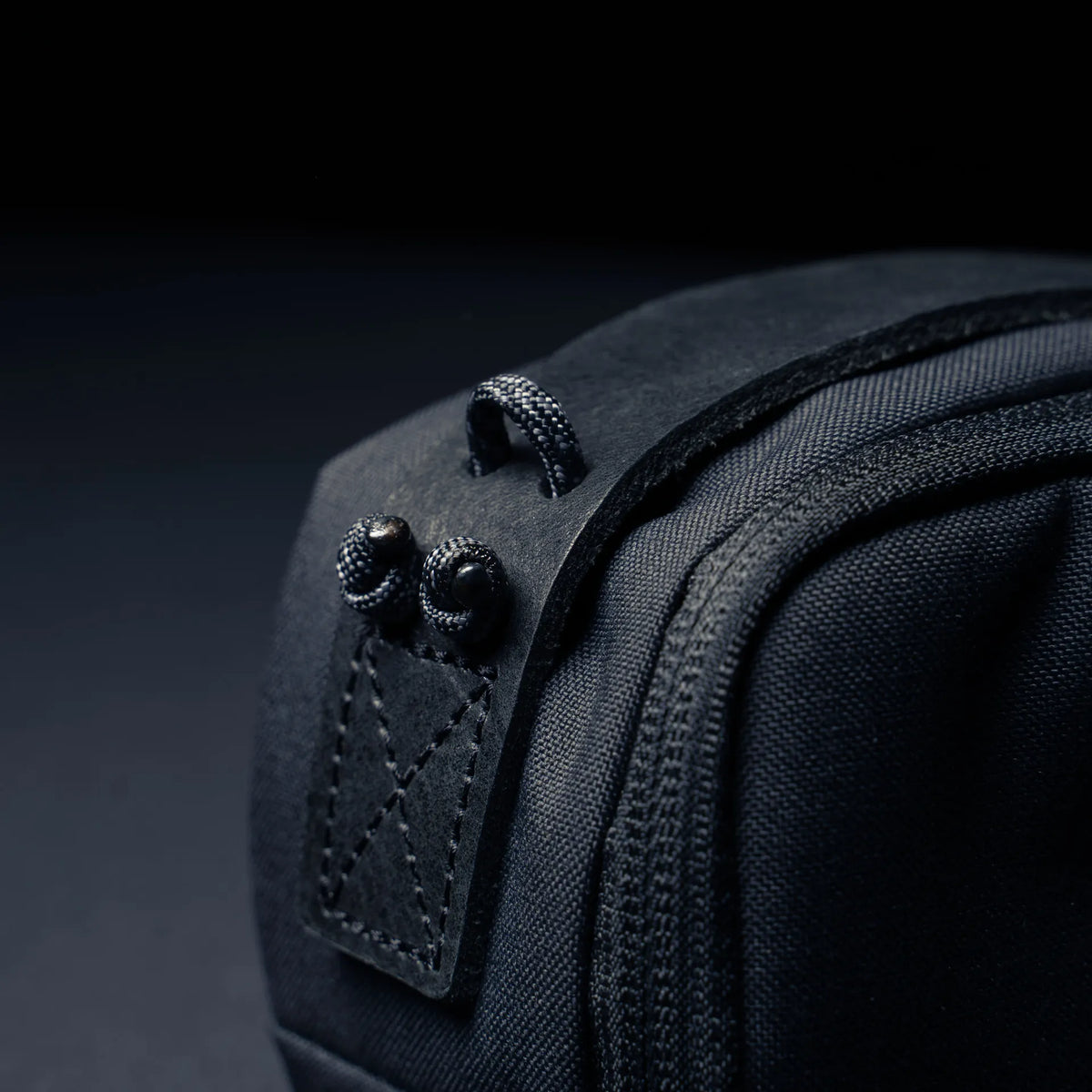 Wotancraft black canvas pouch side tab with paracord loops, close-up