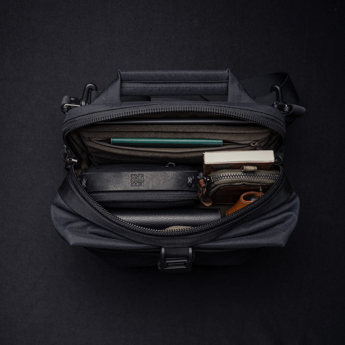 Wotancraft Mini Rider v2 black sling open from above with pouches and notebook