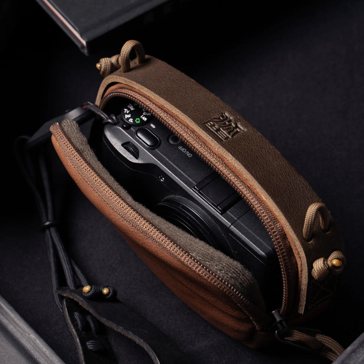 Wotancraft brown leather small pouch open with a Ricoh GR inside