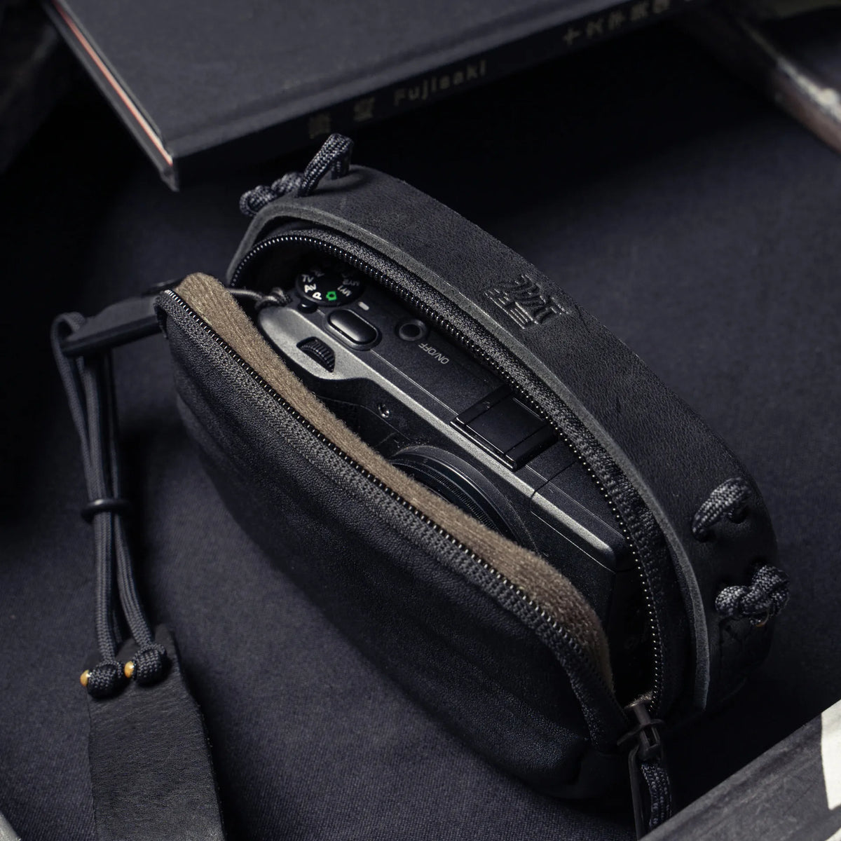 Wotancraft black leather small pouch open with a Ricoh GR inside