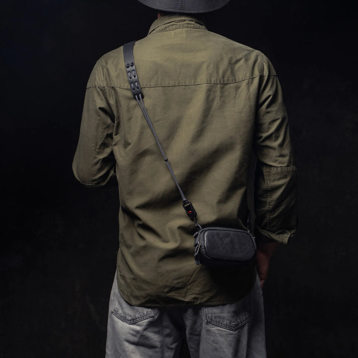 Man wearing the Wotancraft black leather small pouch on a strap, rear view