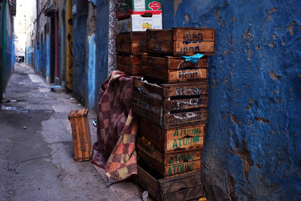Stacked wooden crates in a blue alley, sample photo from the Voigtlander Nokton Classic 35mm f/1.4