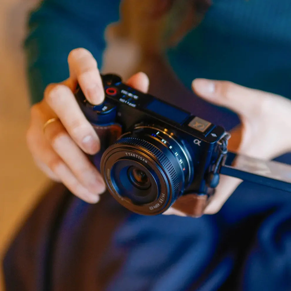 TTArtisan AF 14mm f/3.5 on a Sony mirrorless camera held in hand