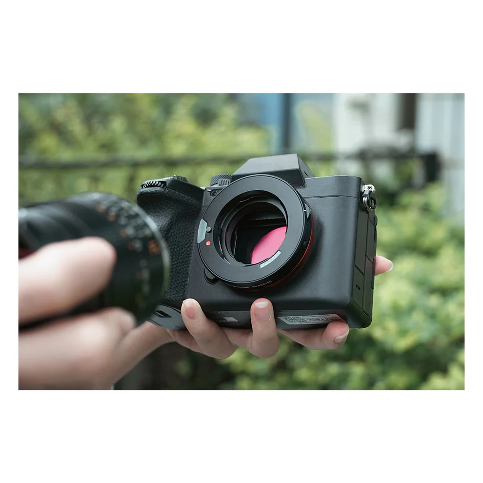 TTArtisan M-E 6-bit adapter II fitted to a Sony mirrorless camera, held in hand