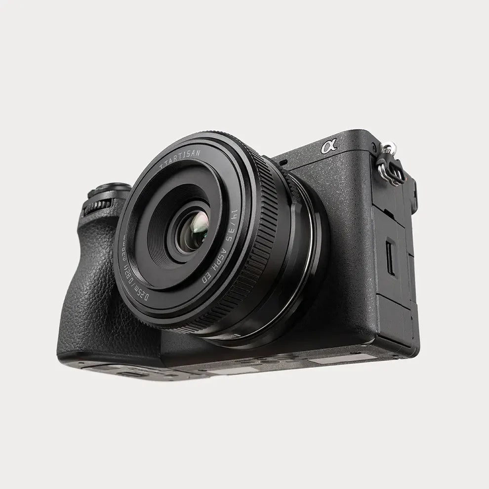 TTArtisan AF 14mm f/3.5 mounted on a black Sony a6700, angled view