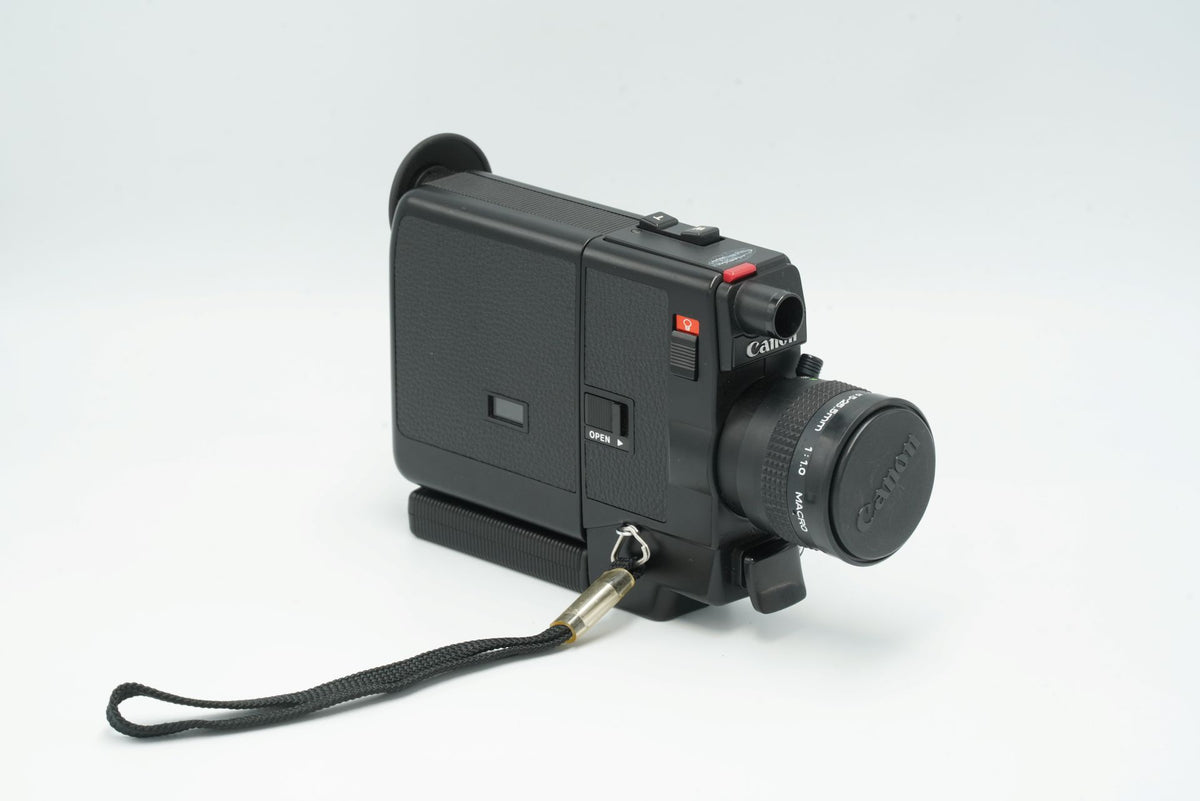 Canon 310XL compact Super 8 camera, side view with film door and lens cap fitted