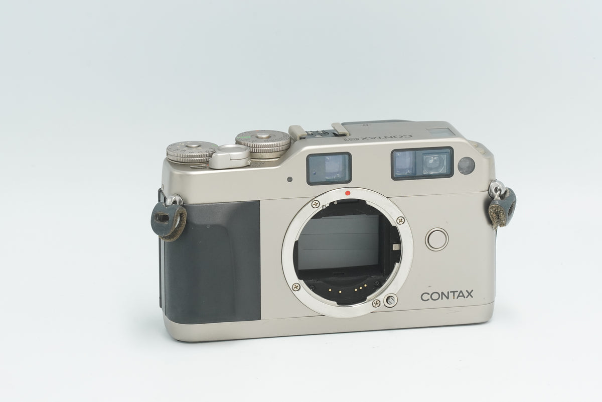 Contax G1 35mm rangefinder film camera body in titanium silver, front view without lens