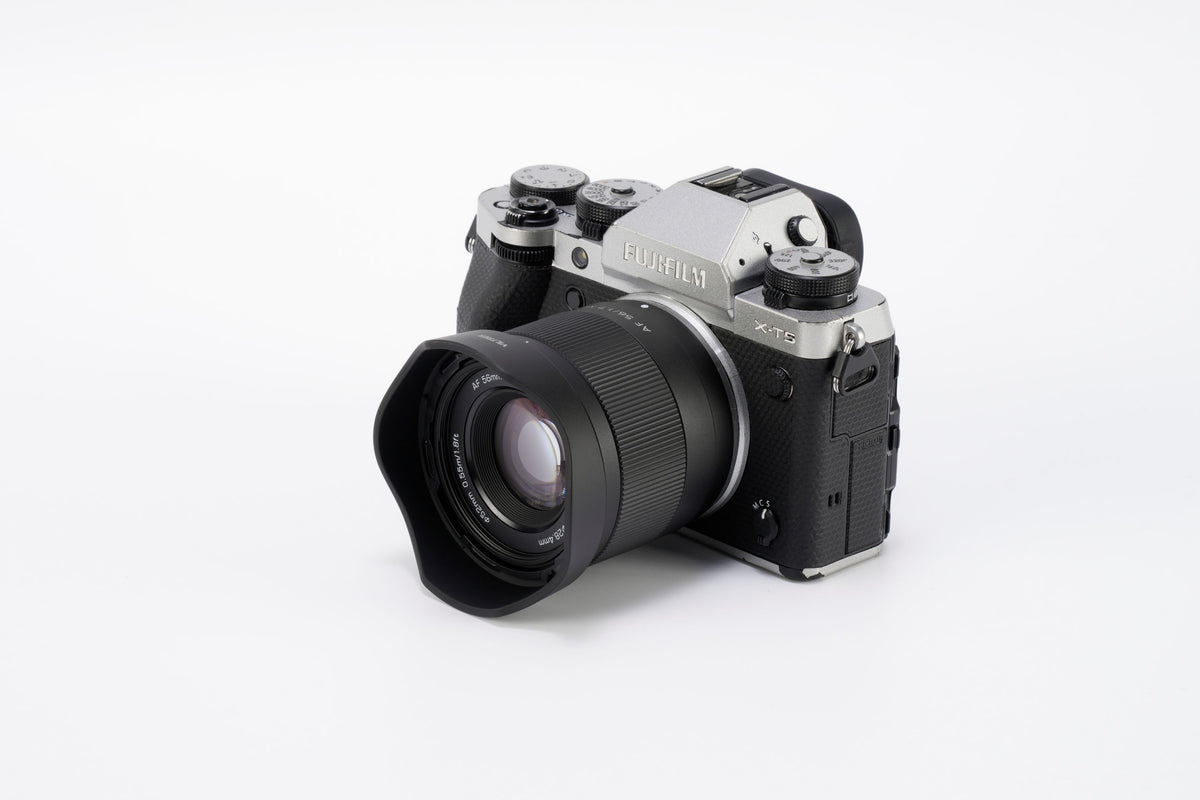 Viltrox Air AF 56mm f/1.7 XF with lens hood on a silver Fujifilm X-T5