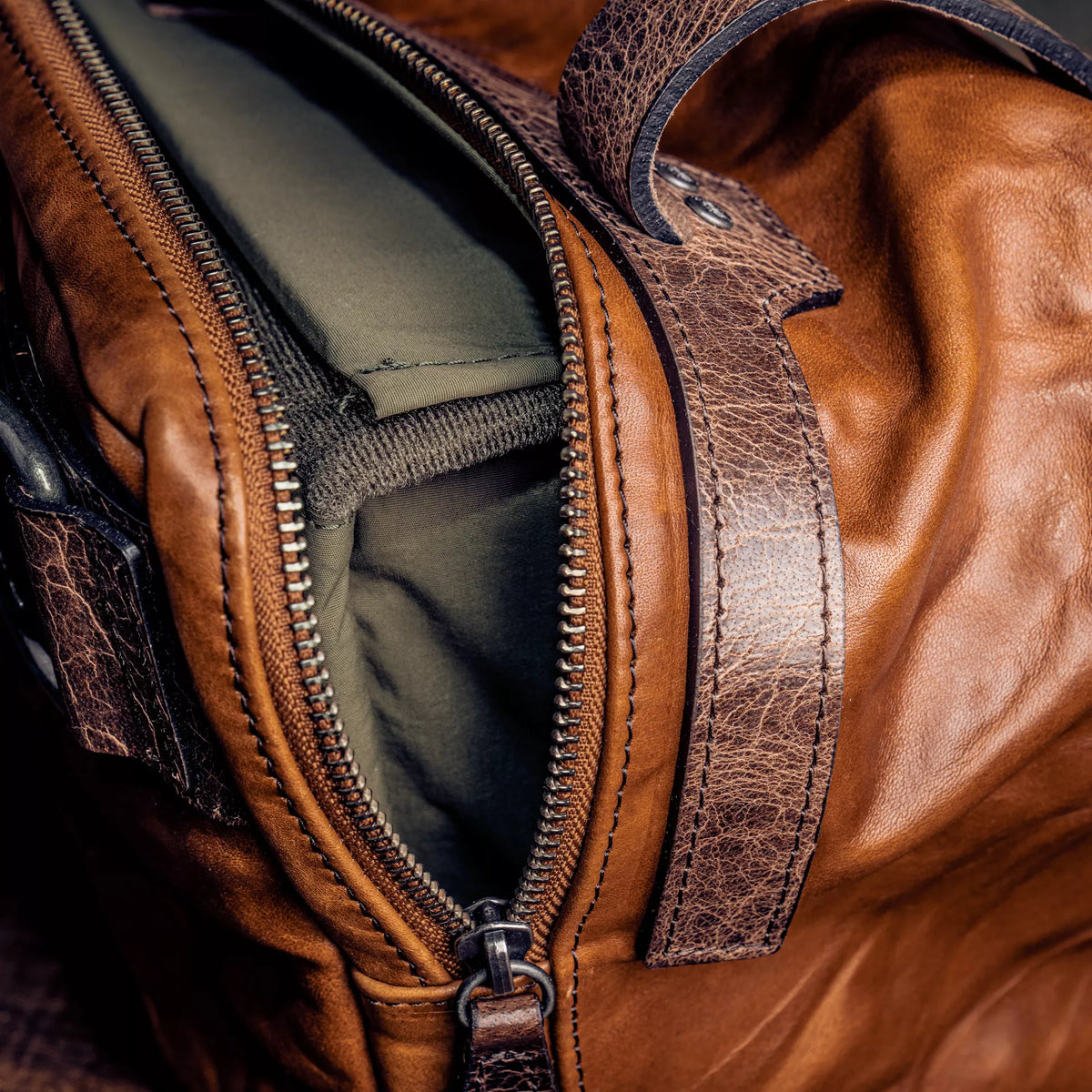 Wotancraft camera insert inside a brown leather bag, zip close-up