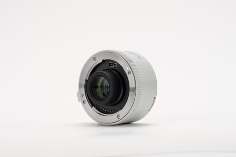 Viltrox 2.0x teleconverter, front angle on a grey background