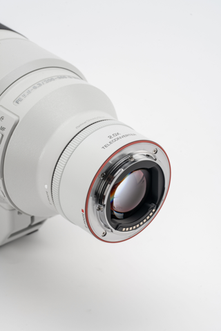 Viltrox 2.0x teleconverter fitted to a white Sony telephoto lens, rear view