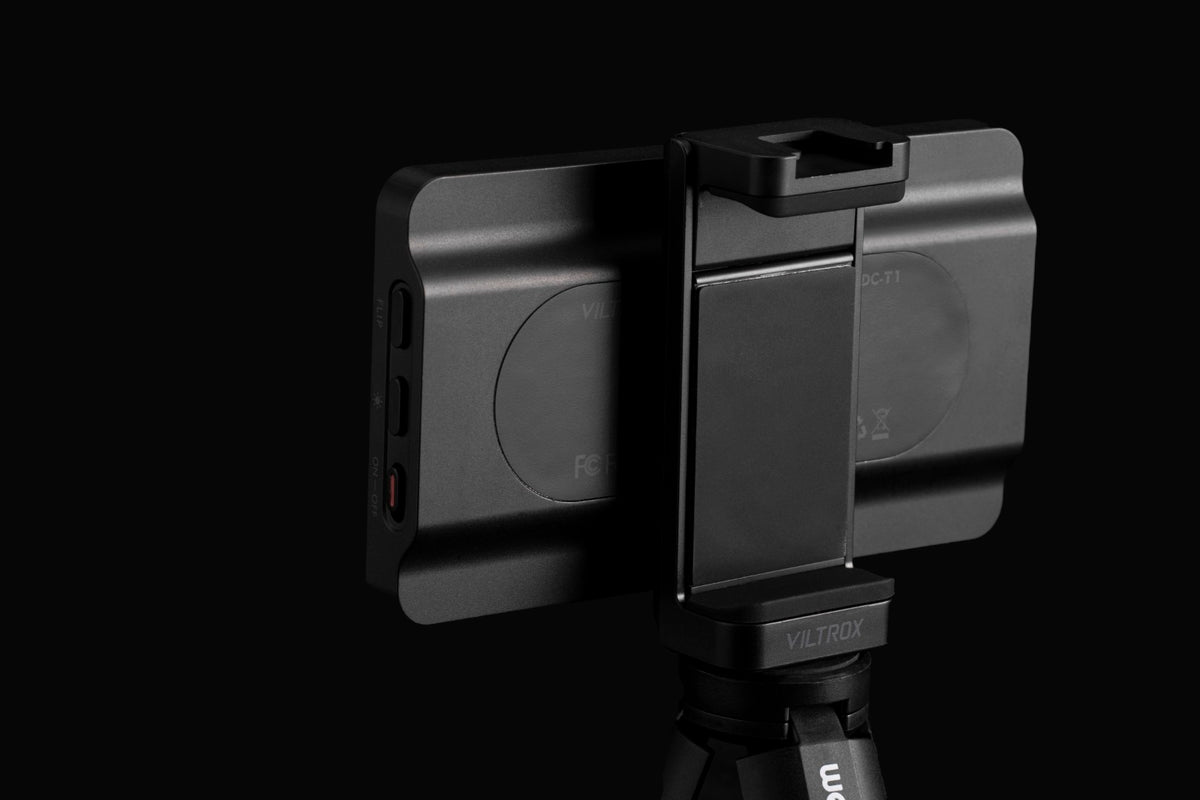 Viltrox DC-T1 rear view mounted in its phone clamp on a tripod