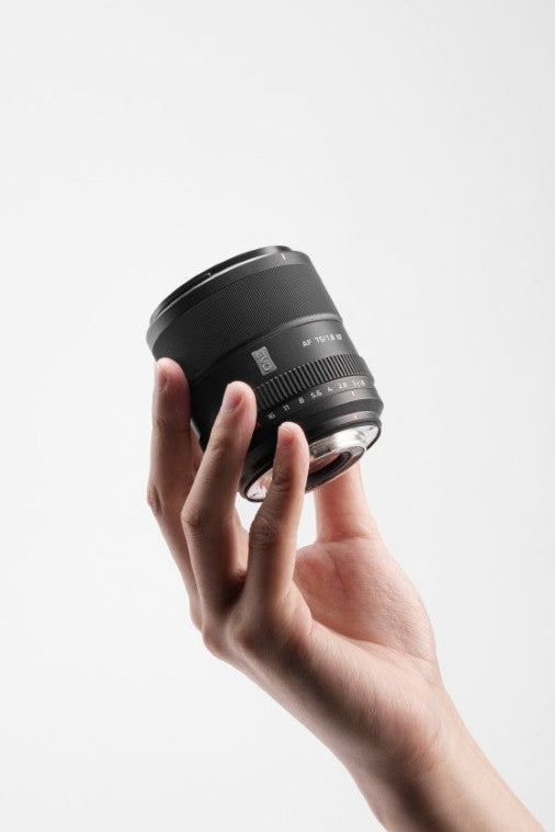 Viltrox AF 75mm f/1.8 XF compact portrait lens held in one hand