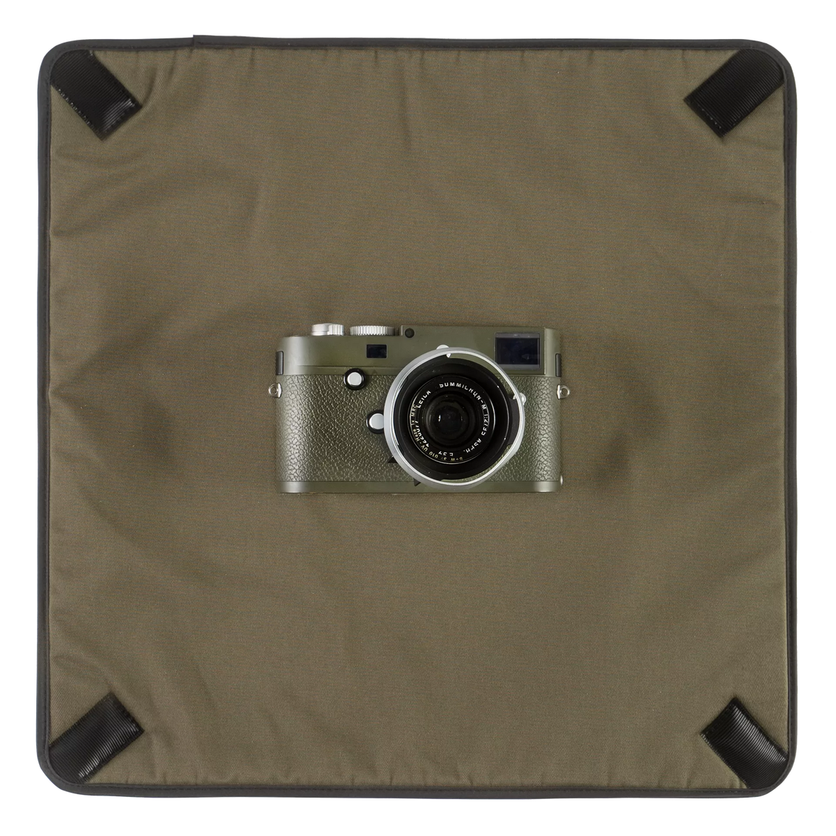 Wotancraft Magician Wrap laid flat with an olive Leica M camera