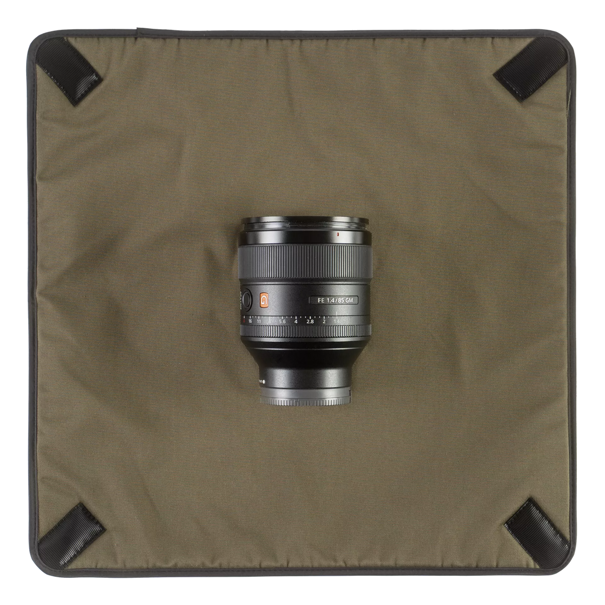 Wotancraft Magician Wrap laid flat with a Sony 85mm lens, olive lining