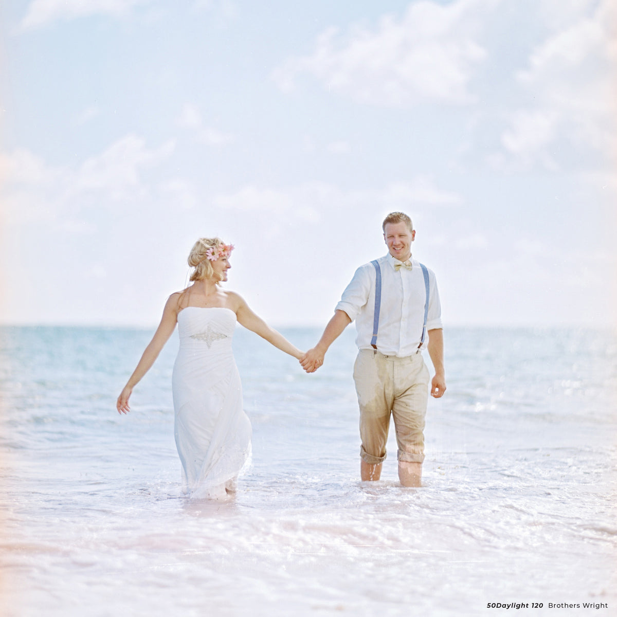 Bride and groom holding hands in the sea, sample shot on CineStill 50D 120