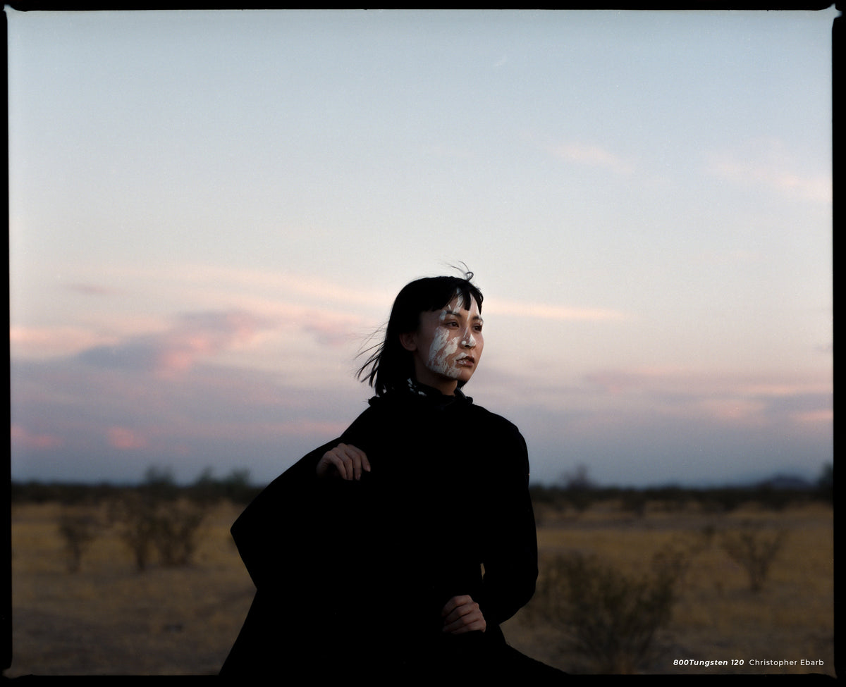 Woman in black in a desert at dusk, sample shot on CineStill 800T