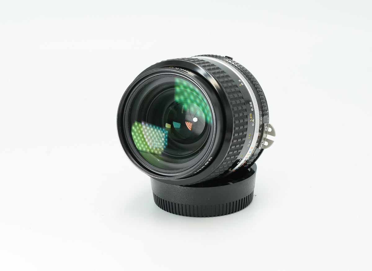 Nikon Nikkor f/2 Ai manual focus wide-angle lens, angled view of the front element