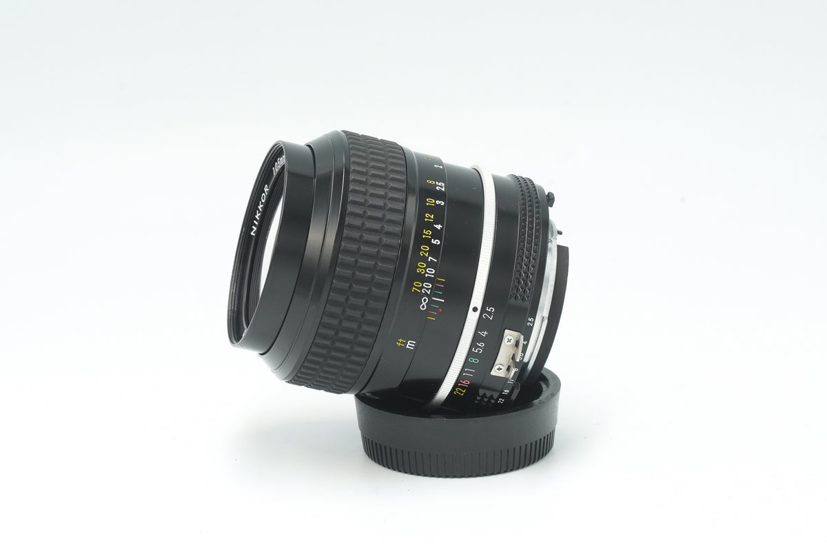 Nikkor 105mm f/2.5 Ai lens, side view with aperture ring and meter coupling prong