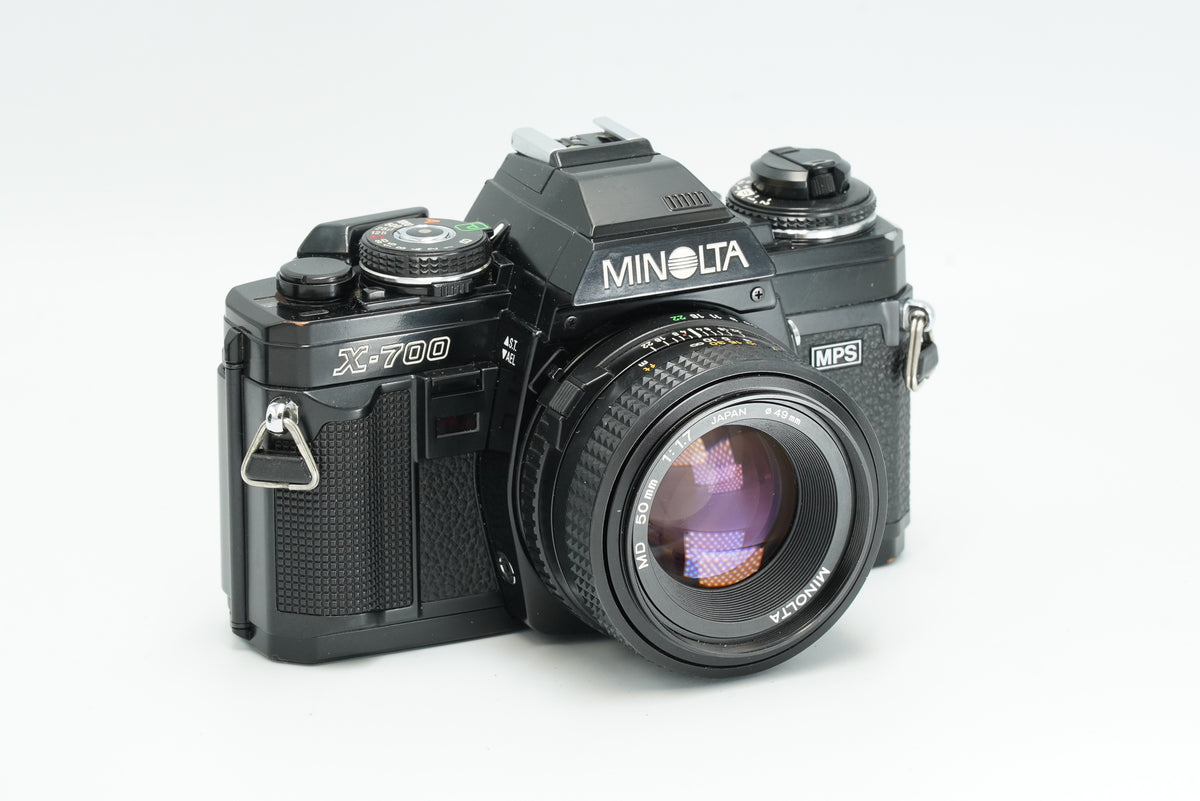 Minolta X-700 black SLR with Minolta MD 50mm lens, angled view