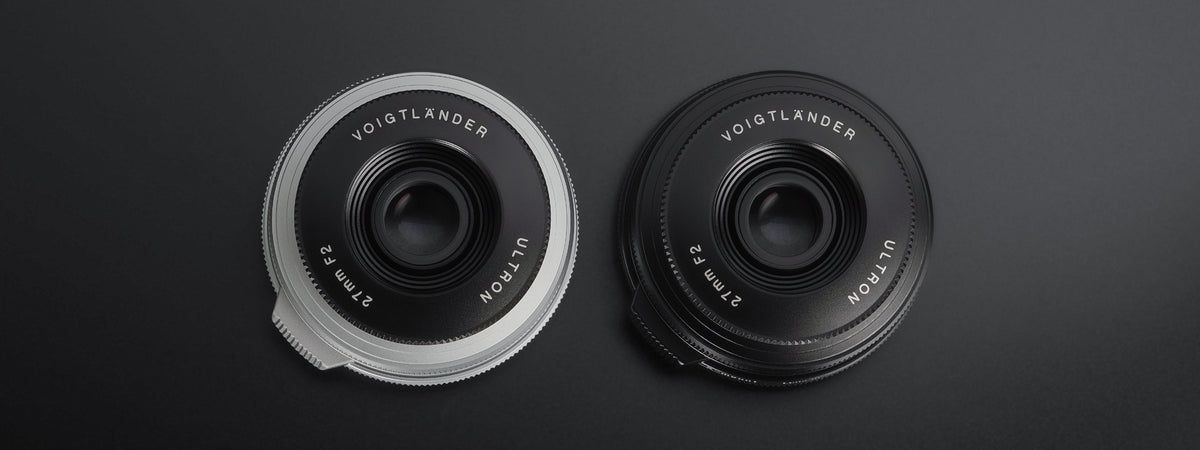 Voigtlander Ultron 27mm f/2 pancake lenses in silver and black, front view