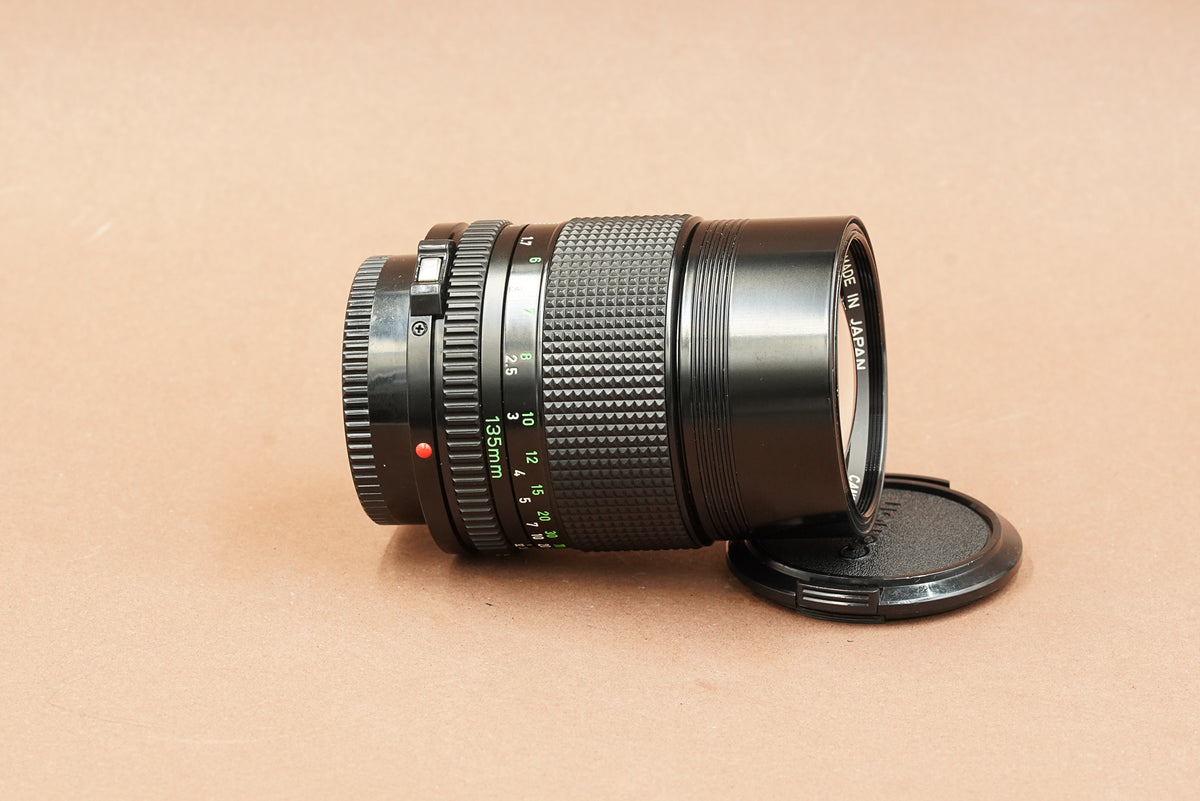 Canon nFD 135mm f/2.8 telephoto lens, side view with focus scale
