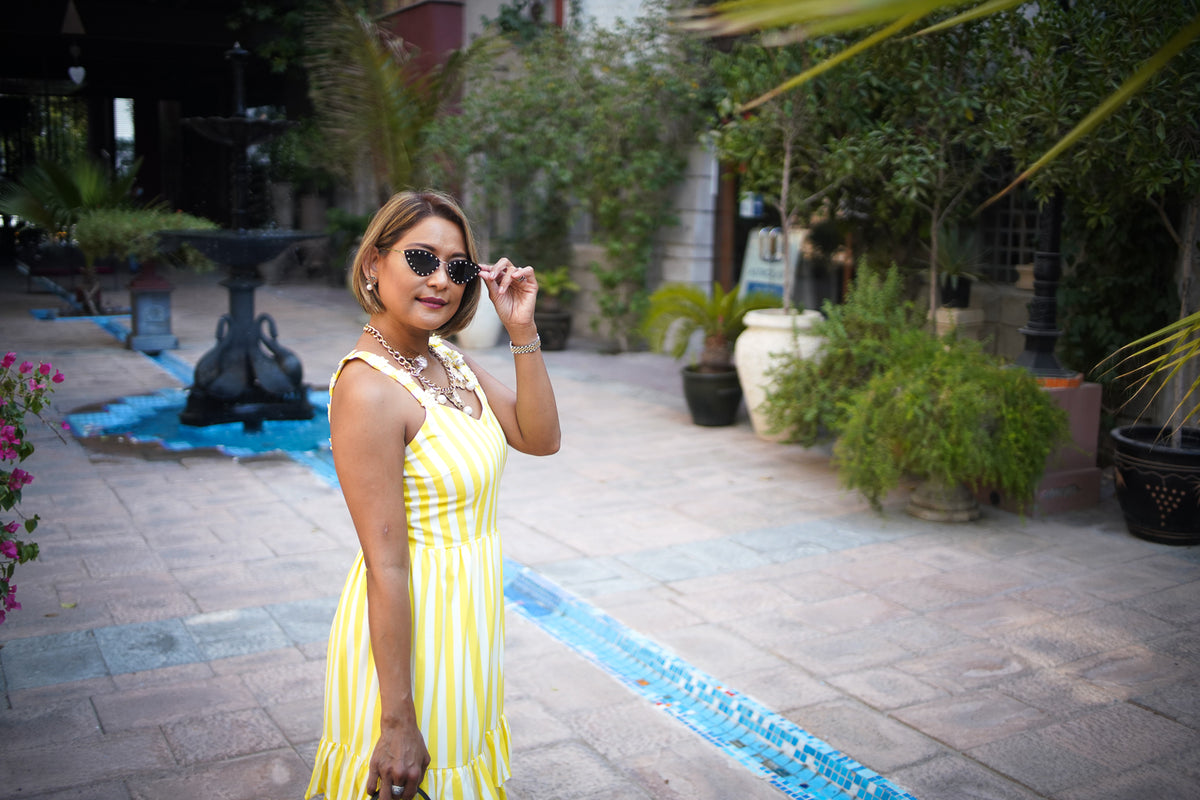 Portrait of a woman in a yellow striped dress, sample photo taken with the Canon nFD 35mm f/2