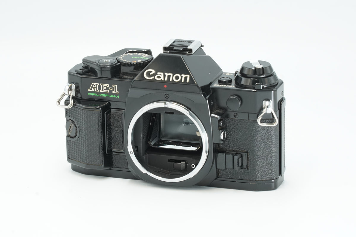 Canon AE-1 Program black 35mm SLR film camera body, front view