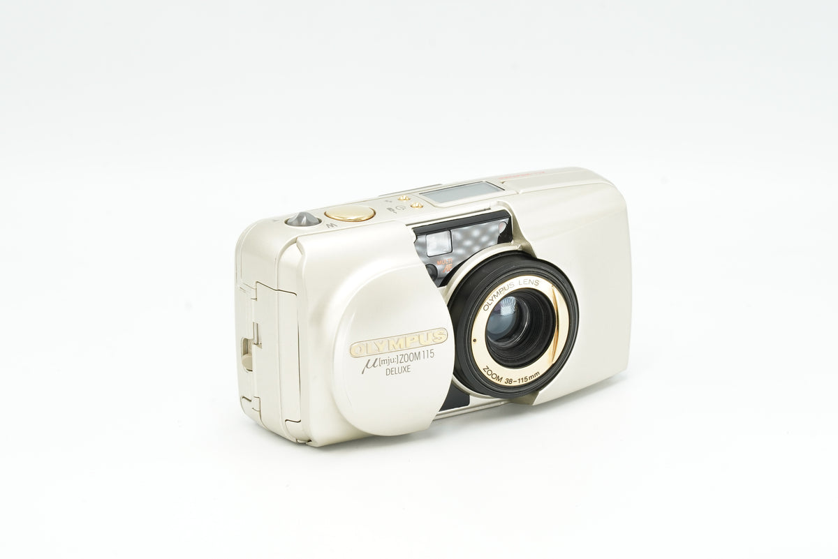 Olympus Mju Zoom 115 Deluxe 35mm point and shoot film camera in champagne, lens open