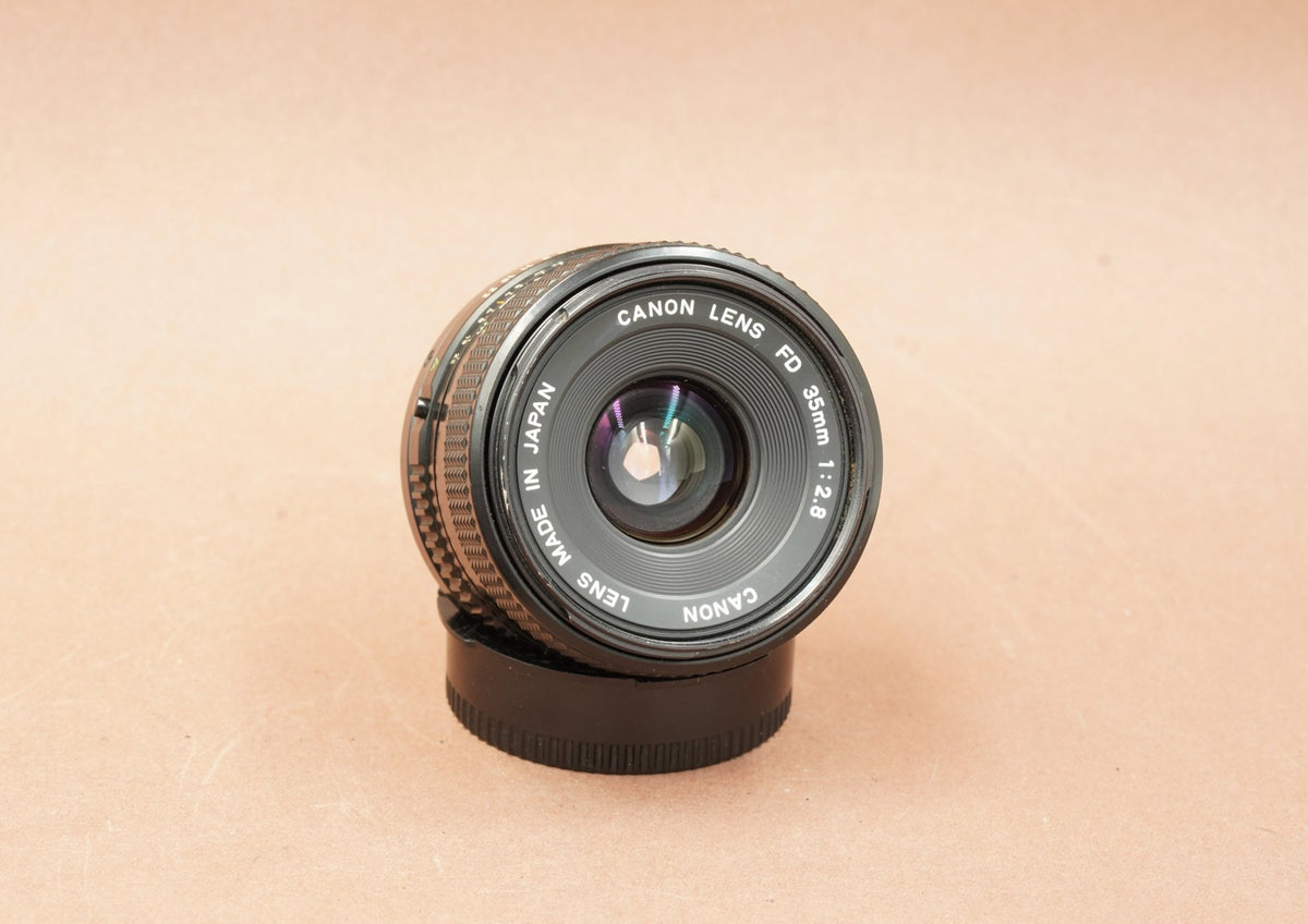 Canon New FD 35mm f/2.8 wide-angle lens, angled view of the front element