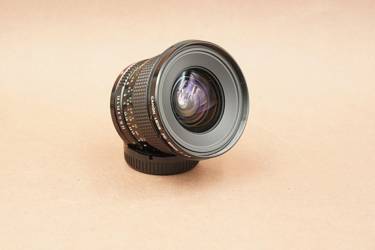 Canon New FD 20mm f/2.8 wide-angle lens, angled view of the front element