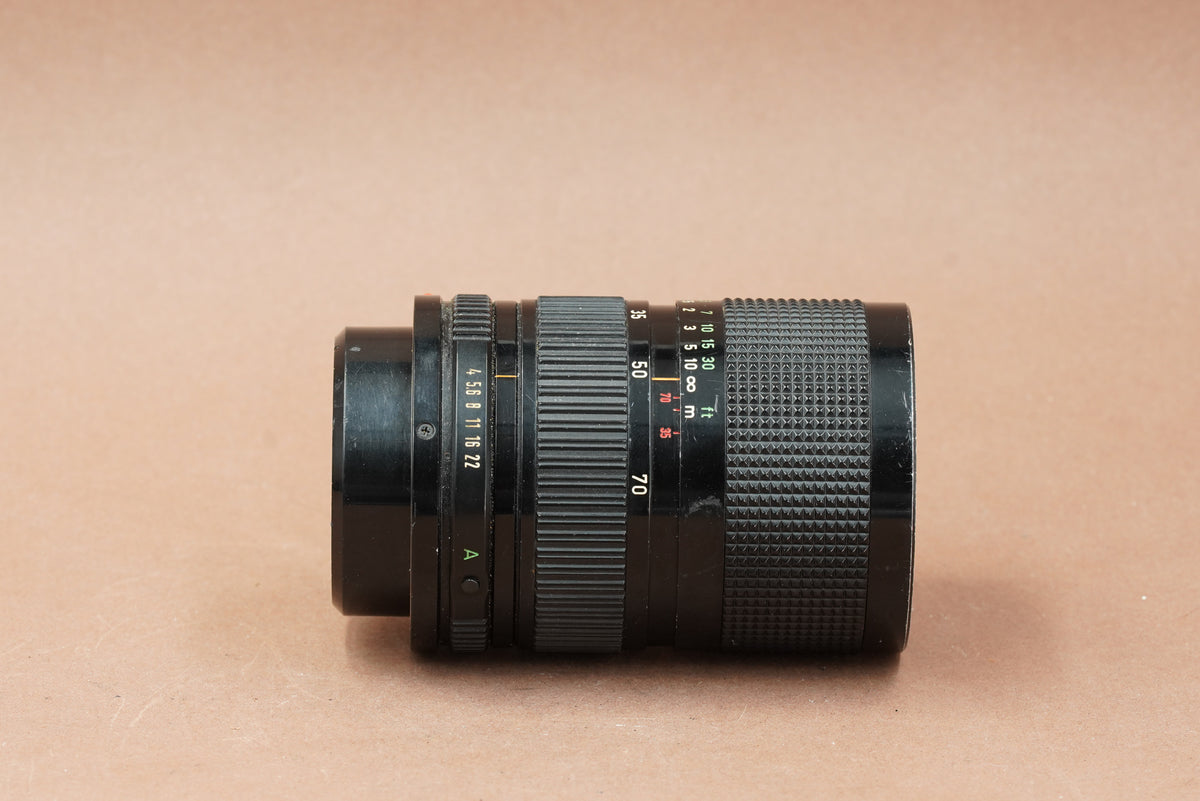 Canon nFD 35-70mm f/4 zoom lens lying on its side