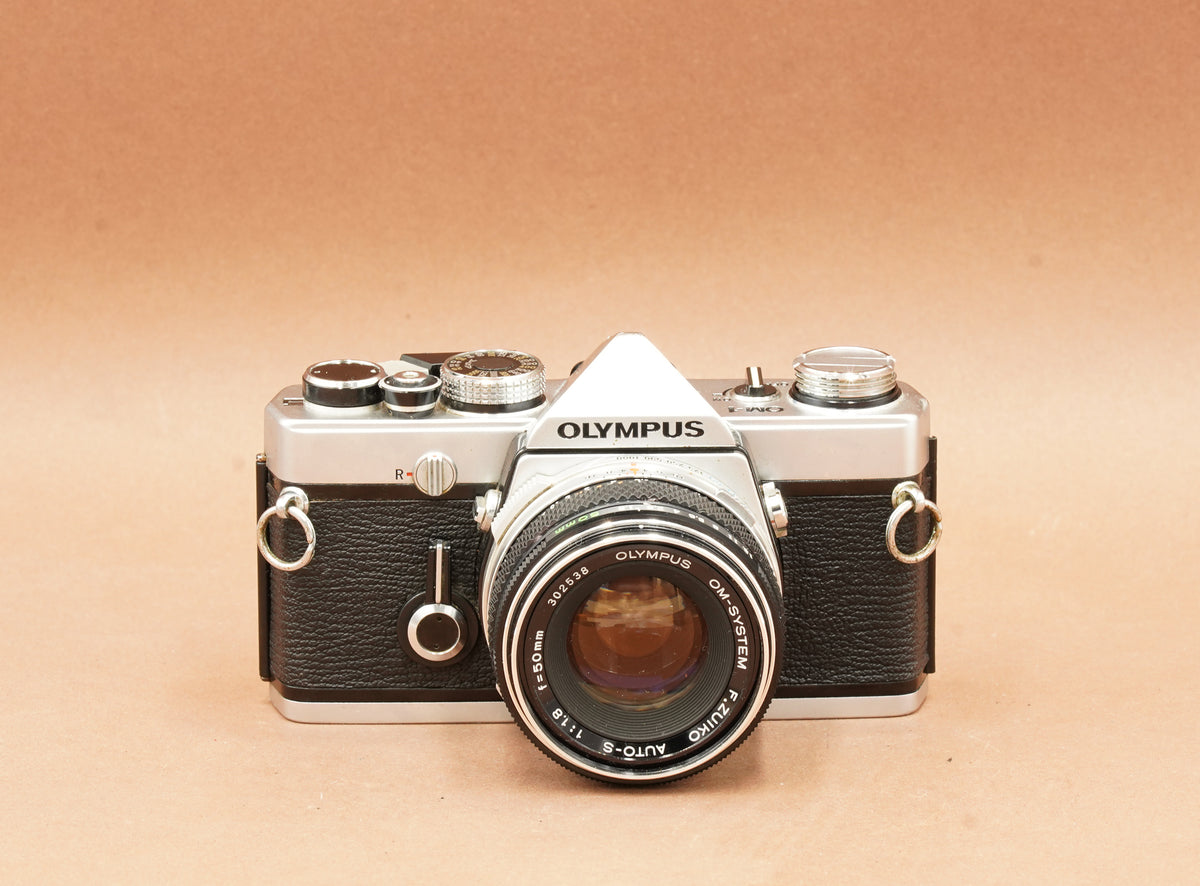 Olympus OM-1 silver with Zuiko Auto-S 50mm f/1.8, front view