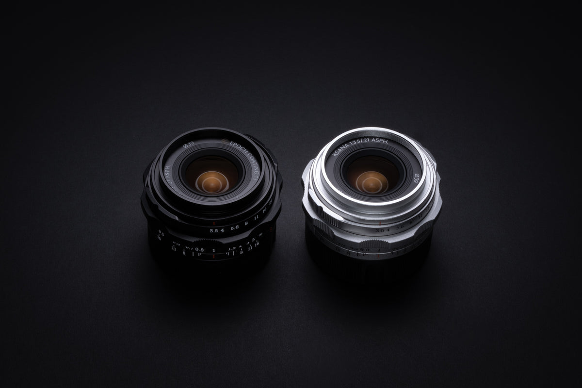Thypoch Ksana 21mm f/3.5 Leica M lenses in black and silver side by side