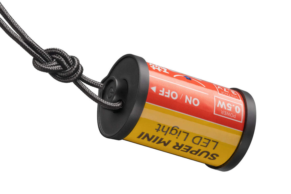 TTArtisan film canister LED light hanging from its lanyard