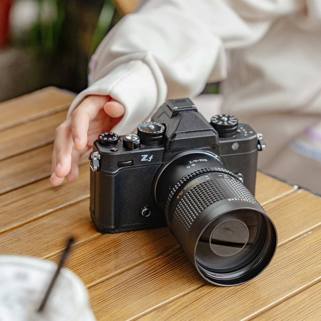 TTArtisan 250mm f/5.6 mirror lens on a Nikon Zf camera on a cafe table