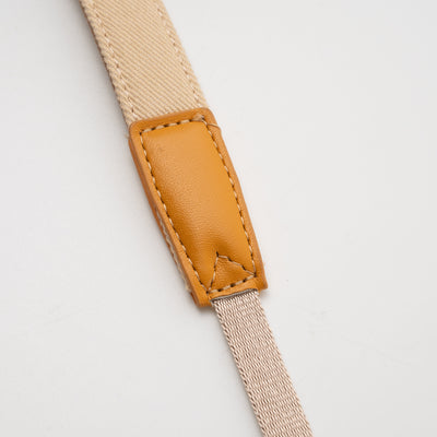 TTArtisan bag strap with tan leather tab, close-up