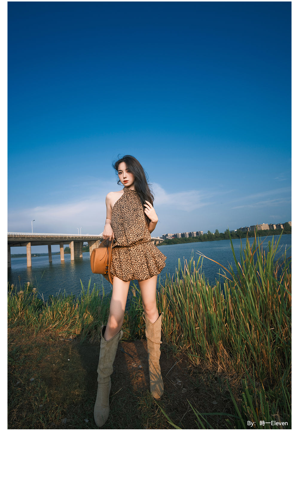 Woman in a leopard print dress by a lake, wide-angle portrait from the TTArtisan 17mm