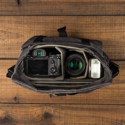 Wotancraft Pilot 7L charcoal bag from above with a Sony camera, lens and flash