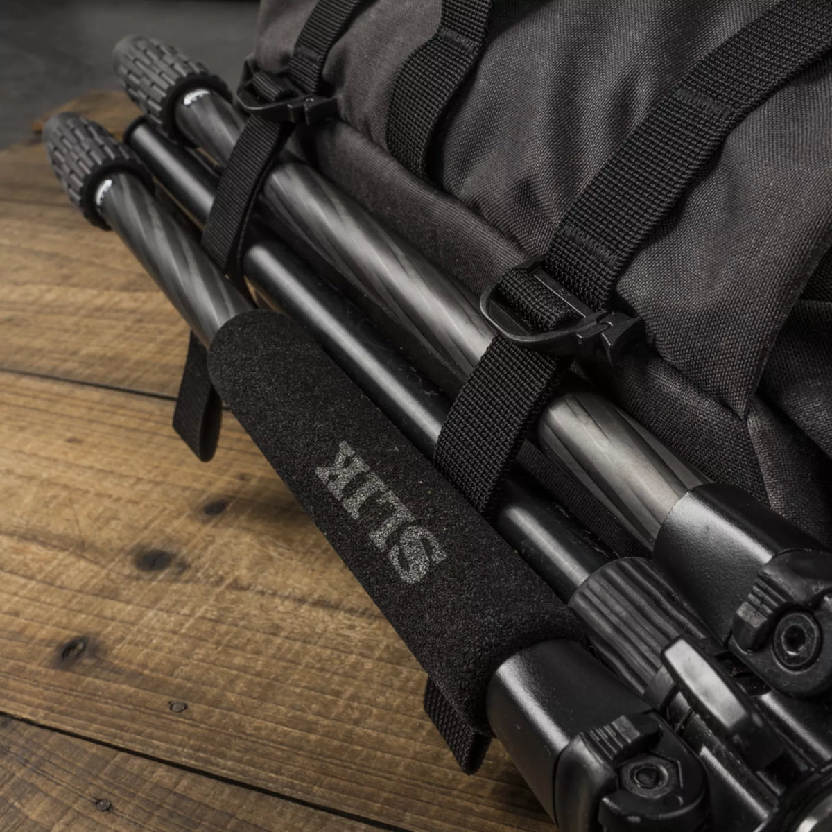 Carbon fibre tripod strapped under a Wotancraft Pilot bag