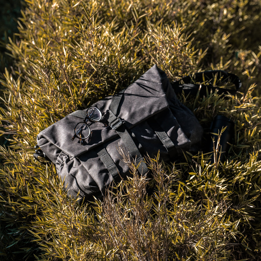 Hands sliding a tablet into the Wotancraft Pilot bag rear laptop sleeve