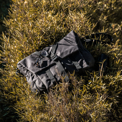 Hands sliding a tablet into the Wotancraft Pilot bag rear laptop sleeve