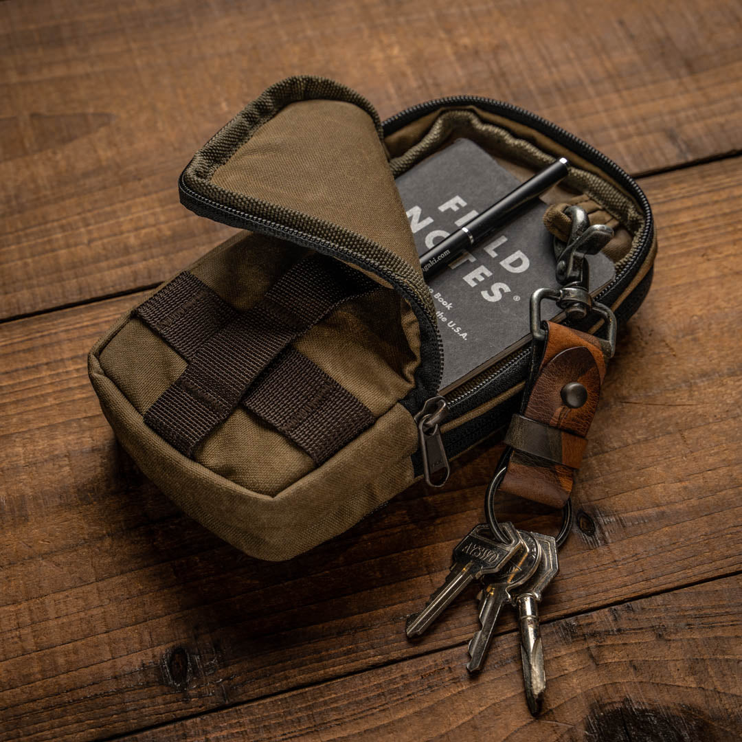 Wotancraft khaki zipper pouch open with notebook, pen and keys