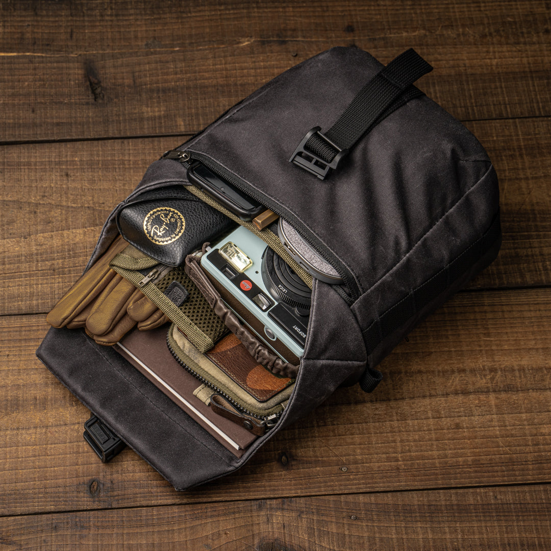 Wotancraft Pilot 3.5L black bag open with gloves, Leica camera and notebook